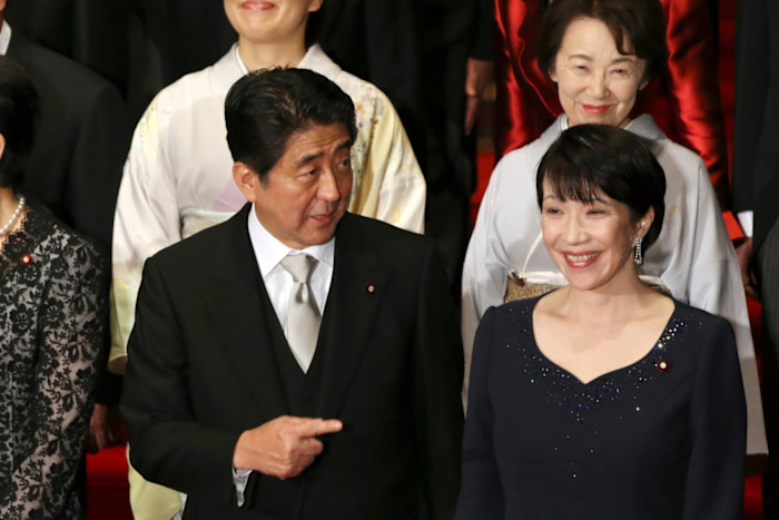 Japan’s then-prime minister Shinzo Abe points to his internal affairs minister Sanae Takaichi while posing with his cabinet in Tokyo in 2014