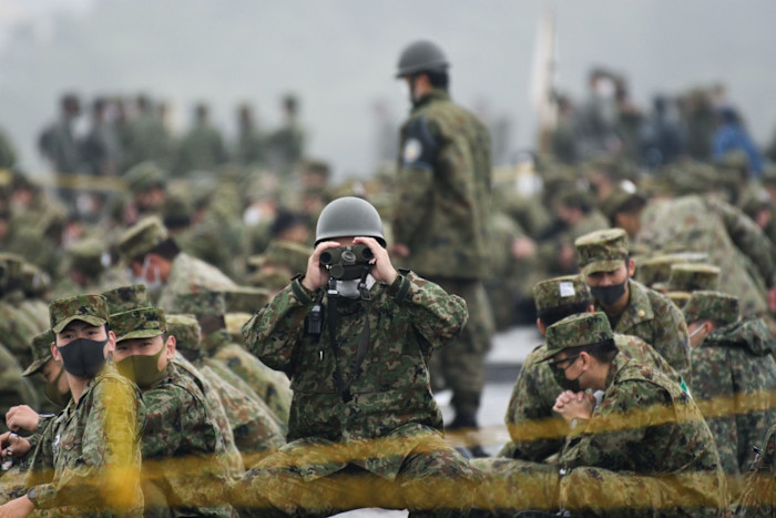 A Japan’s Ground Self-Defense Forces soldier uses binoculars during a live-fire exercise in 2021