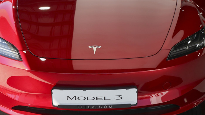 Close-up of the front of a red Tesla Model 3 car