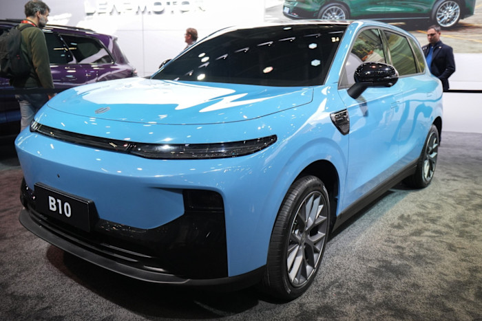 A Leapmotor B10 compact electric SUV in light blue on display at the Paris Motor Show, viewed from the front left side.