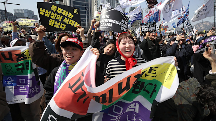 South Koreans celebrate after hearing the Constitutional Court’s verdict