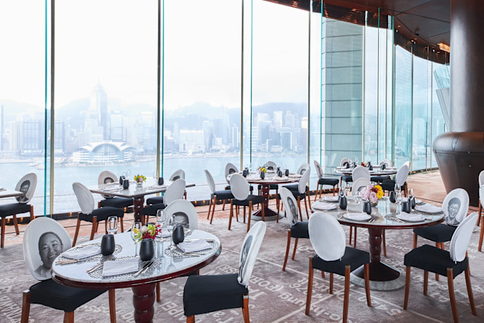 Tables and chairs by floor-to-ceiling windows looking over the harbour and city in the Philippe Starck-designed Felix restaurant and bar on the hotel’s 28th floor.