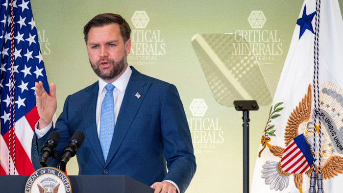 Vice-president JD Vance gestures while speaking at a podium during the Critical Minerals Ministerial meeting.