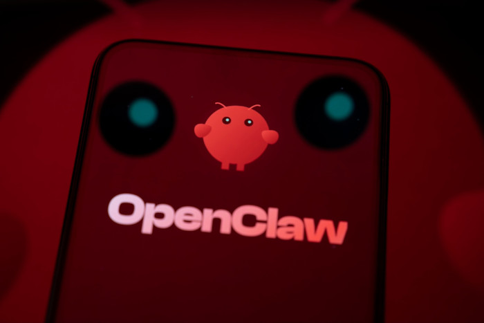 The OpenClaw logo and mascot are displayed on a smartphone screen, with the mascot also projected on to the reflective surface below.