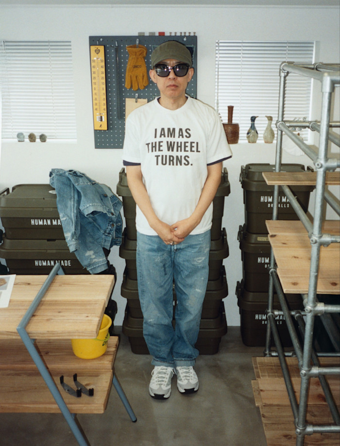 His signature double denim (jacket on crates) and Human Made sneakers