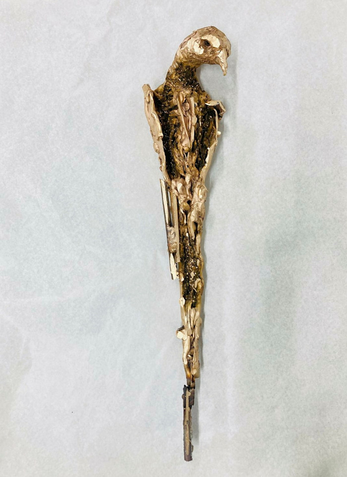 A bronze sculpture by Lionel Sabatté depicting a solitary bird with an elongated, textured body and a downward-turned head.