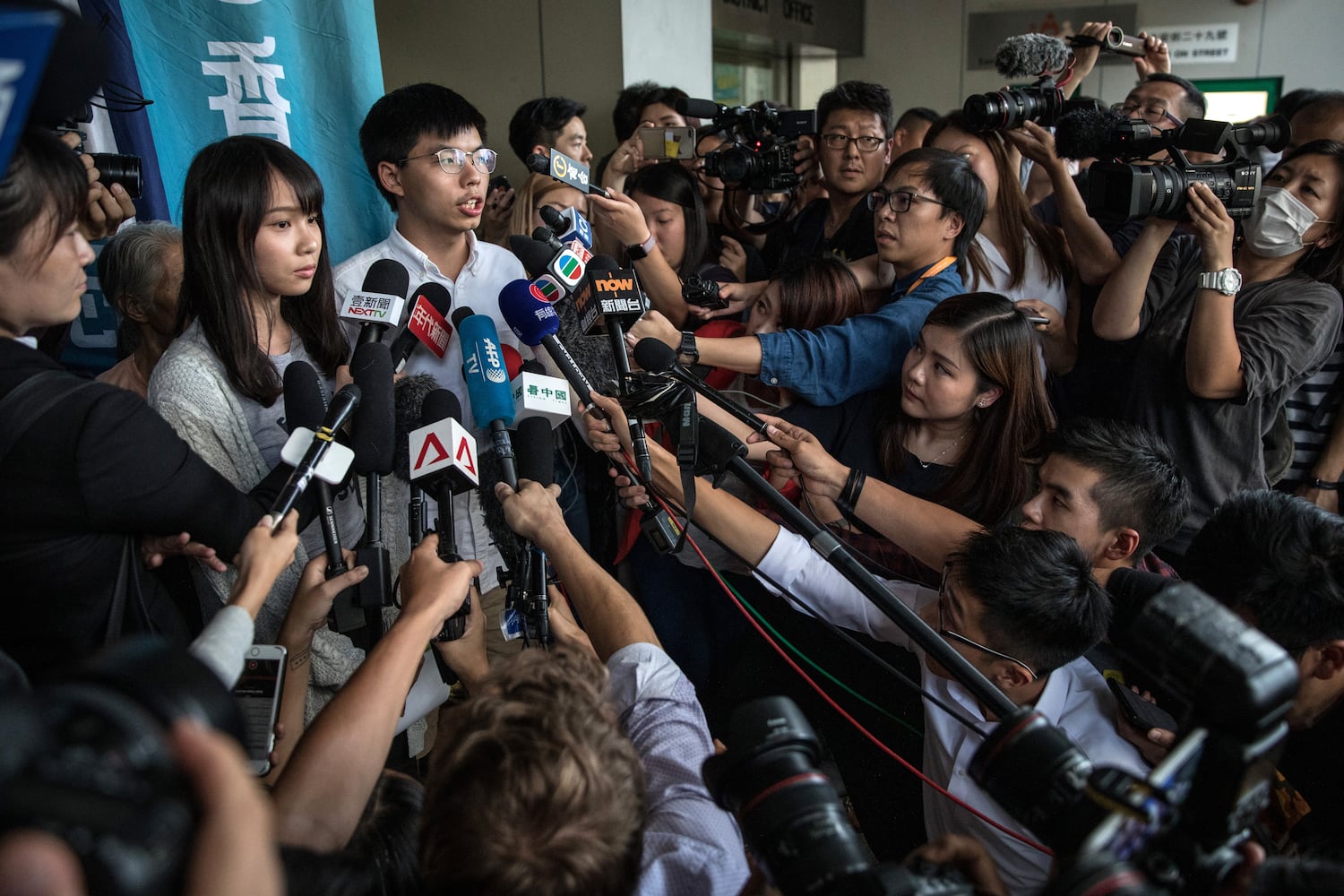 Hong Kong pro-democracy activists Agnes Chow, left, and Joshua Wong speak to the media after being arrested and released on bail on August 30, 2019 in Hong Kong. (Chris McGrath/Getty Images)
